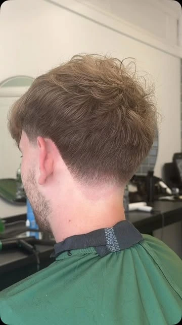 A finished tapered haircut with natural texture